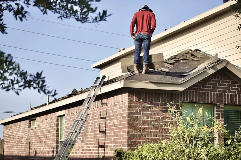 Professional roofer working on a residential roof in Banbury Oaks